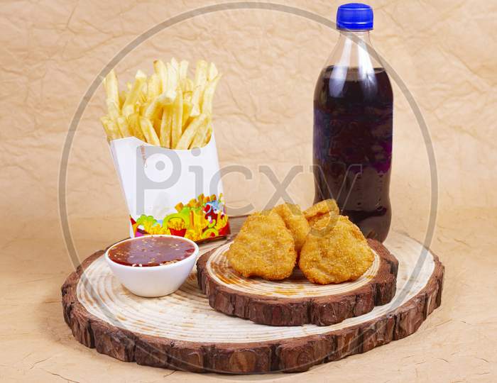 Chicken Nuggets With Cold Drink,Fries And Ketchup On A Wooden Board, Close-Up