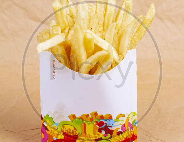 French Fries Potatoes In Paper Bag. Isolated On White Background