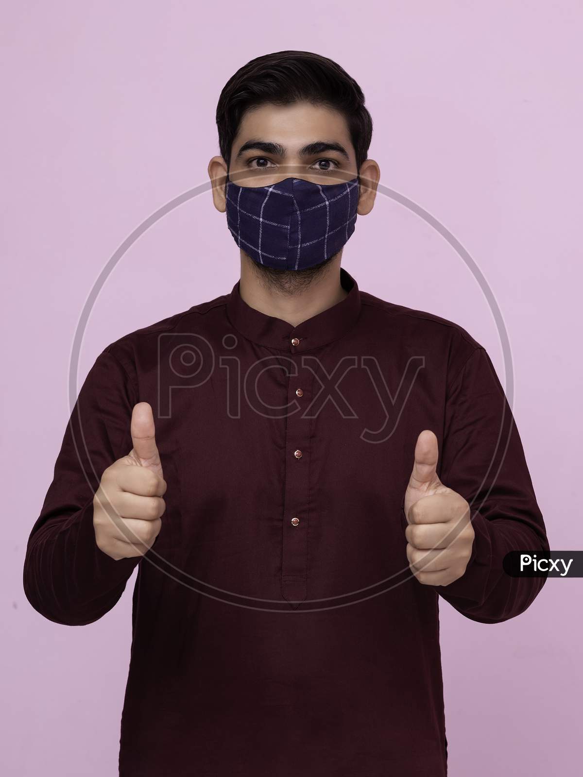 Indian Adult Boy Wearing Mask With Thumbs Up Gesture.