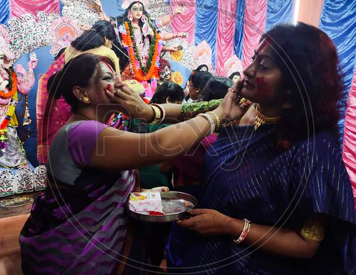 Kolkata, West Bengal, India - 15 October 2021: Married Bengali Hindu Women Smear And Play With Vermilion During Sindur Khela Traditional Ceremony On The Final Day Of Durga Puja Festival.