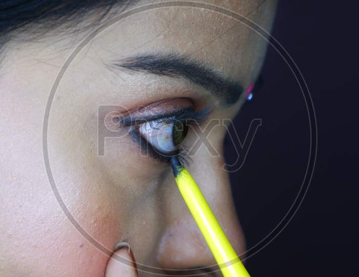 Close Up Image Of Indian Girl Putting Kajal On Eyes.