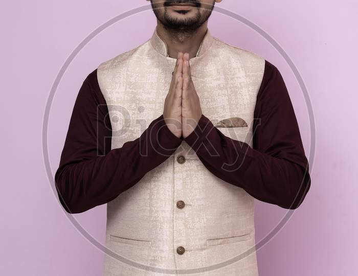 A Portrait Of A Indian Man In A Traditional Wear In Welcome Gesture Pose - Namaste.
