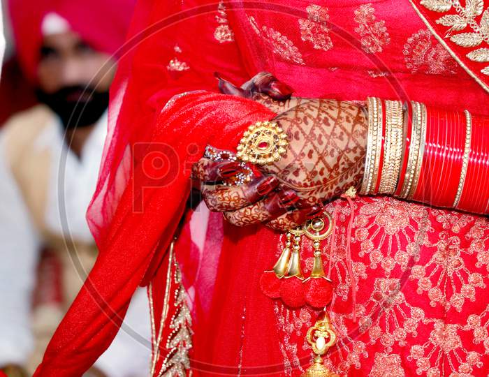 Close Up Of Decorative Hands Of Indian Bride With Golden Jewellery.