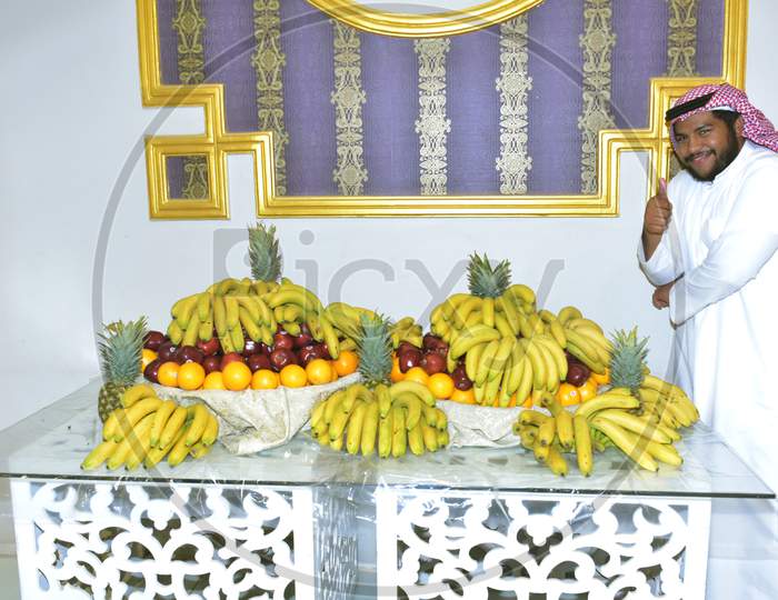 July 2020,Wedding Hall Riyadh,Saudi Arabia, A Saudi Man Standing To Serve Fruits Decorated On A Table During Wedding Event In Wedding Hall Riyadh