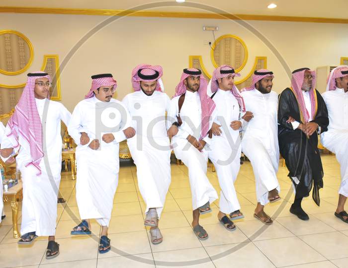 July 2020, Wedding Hall Riyadh, Saudi Arabia, Saudi Men Celebrating And Enjoying Traditional Dance With Cultural Objects In Hands During Wedding Event In Wedding Hall Riyadh Saudi Arabia