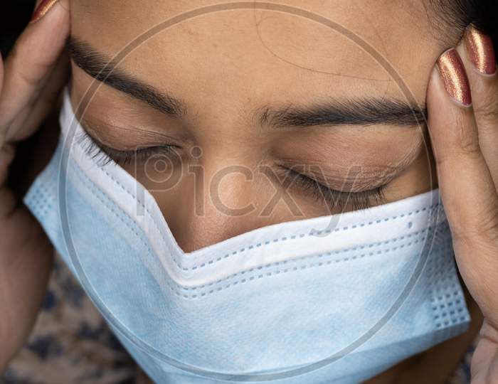 Girl Suffering From Headache Pain Due To Using Of Mask.