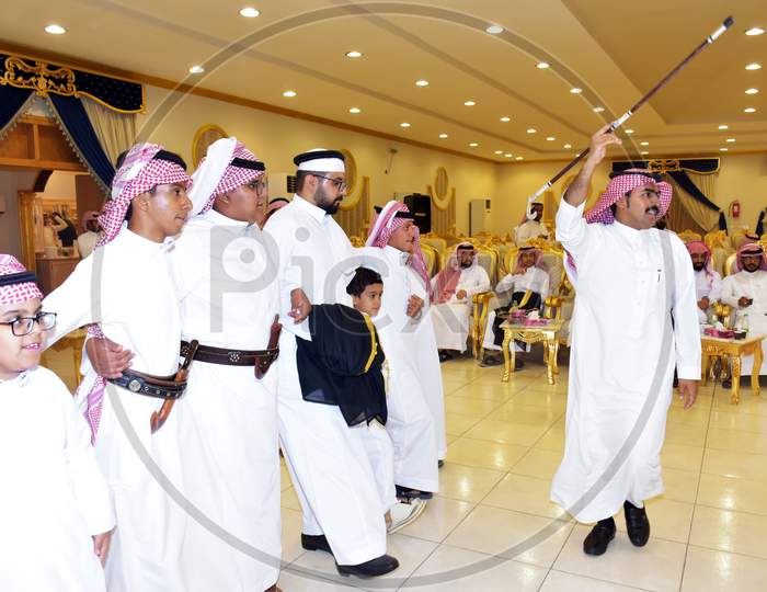 July 2020, Wedding Hall Riyadh, Saudi Arabia, Saudi Men Celebrating And Enjoying Traditional Dance With Cultural Objects In Hands During Wedding Event In Wedding Hall Riyadh Saudi Arabia