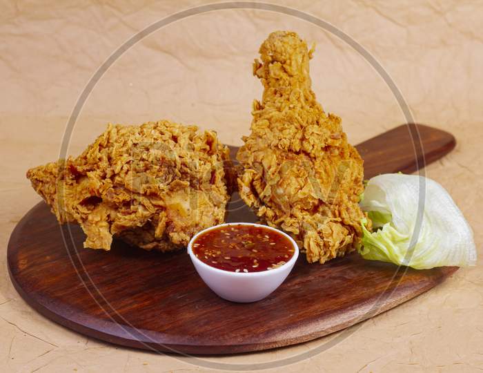 Hot And Crispy Fried Chicken Legs Isolated On A Wooden Wooden Platter