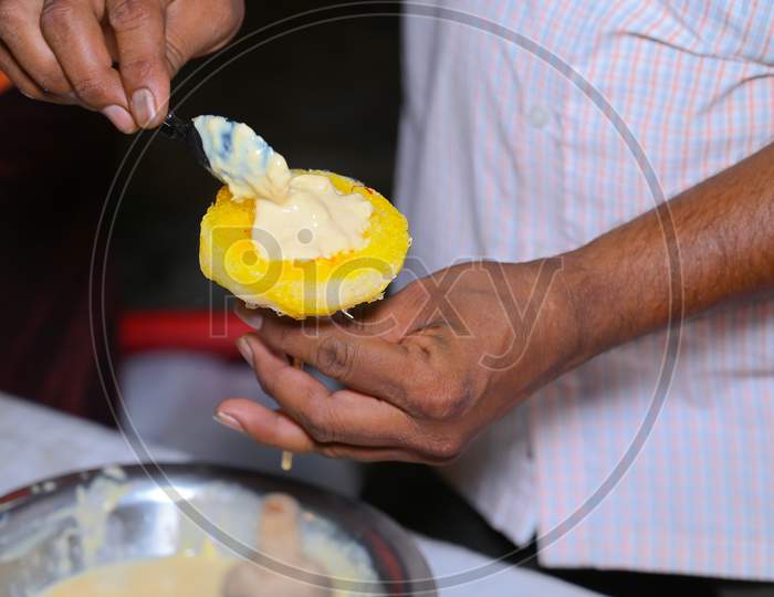 A Picture Of Hands Of A Hawker Holding Ice Gola (Ice Candy)