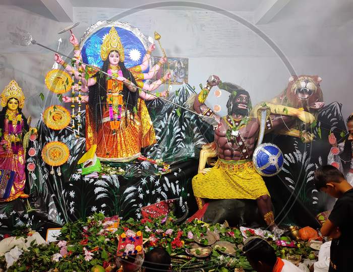 Goddess Durga being worshipped in a pandal during Durga puja in West Bengal, India. Selective focus on face.