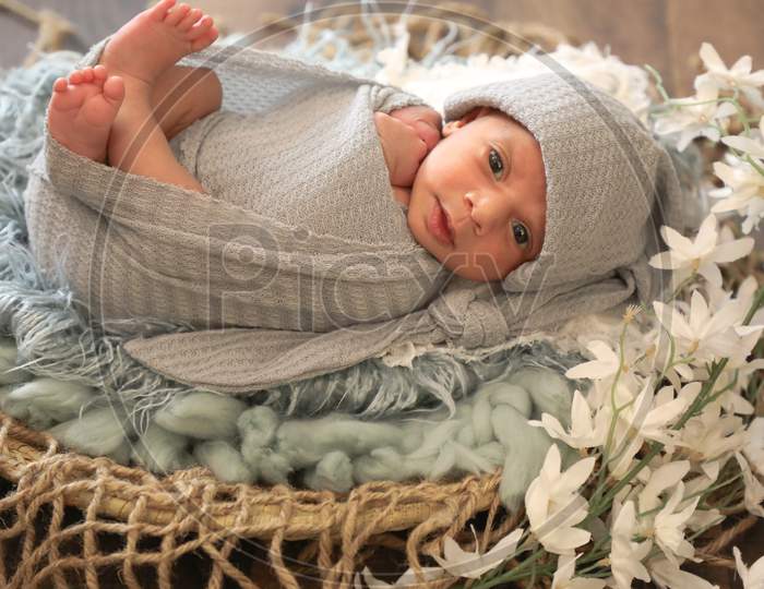 6 Months Old Little Sweet Arab Muslim Girl Laying And Posing On Comfy Wool Cute Face Top View