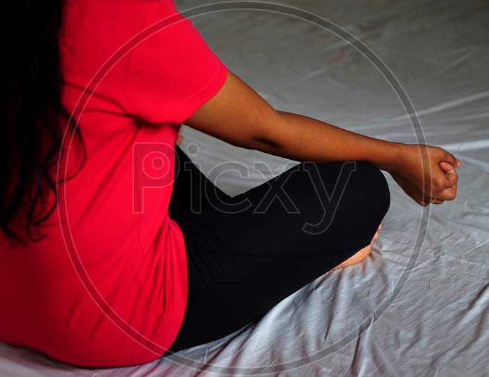 Indian Woman Practicing Yoga In Sitting And Meditating Pose