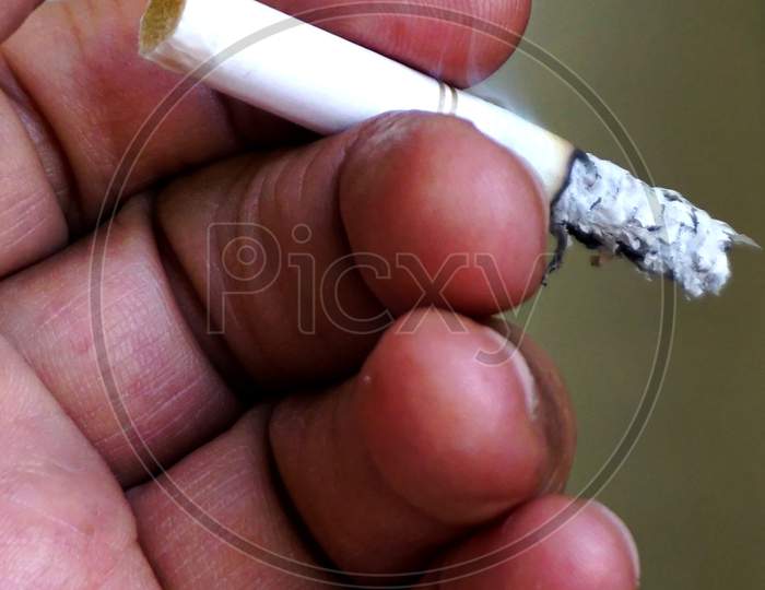 View Of Hand And Fingers Of A Man Holding Cigarette, No Smoking Concept