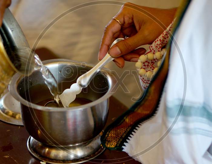Holy Water Or Coconut Water In A Vessel Given To Devotees By Priest In A Hindu Temple