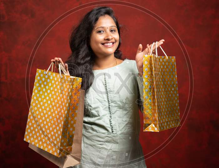 Happy Smiling Indian Woman With Shopping Bags Looking At Camera - Concept Showing Of Shopaholic And Holiday Festival Shopping Sales And Offers.
