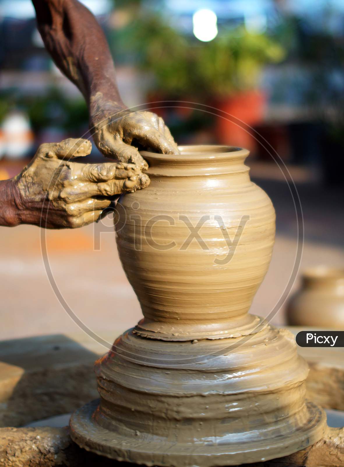 Stock Photo Of Potter Making A Eathen Vase On The Wheel In Outdoors