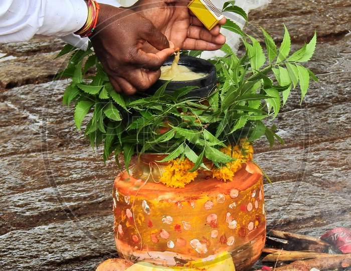 Ndian Hindu Man Lighting The Oil Lamp On Bonam, Afood Offering To Goddess Durga During Bonalu Festival,On The Way To Temple