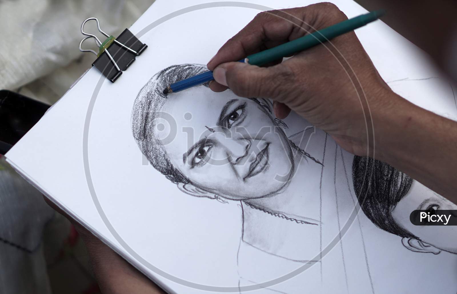 Indian Artist Drawing Pencil Portrait Of A Woman In A Public Place
