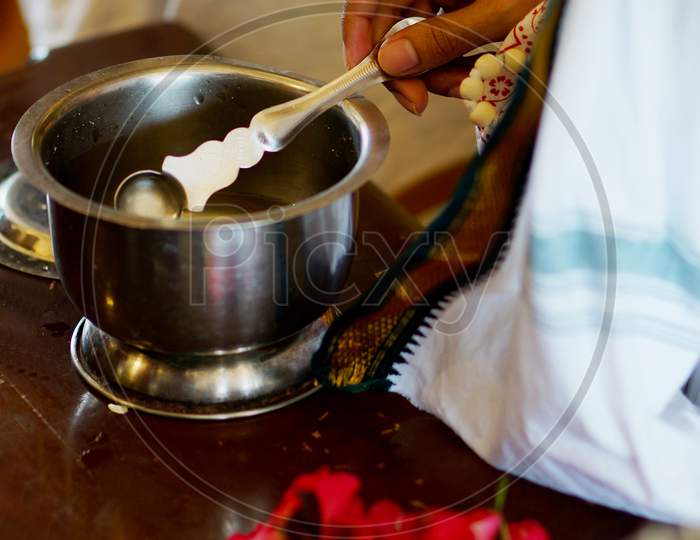Holy Water Or Coconut Water In A Vessel Given To Devotees By Priest In A Hindu Temple