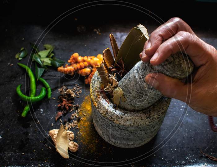 Picture of a masala pot where tasty and healthy spices are being crushed. The ancient Indian method to crush the spices.