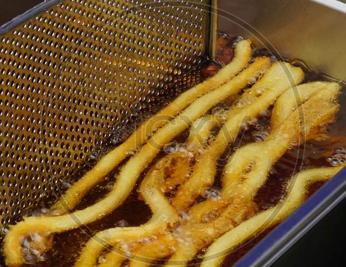 View Of Deep Frying Of Potato Chips,In Oil ,By Indian Street Food Vendor