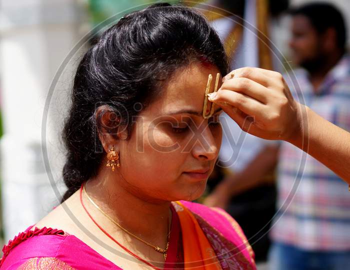 Indian Hindu Woman Apply Tilak On Fore Head Of A Devotee,A Religious Ritual,On Krisnastami Festival Celebration In God Krishna Temple