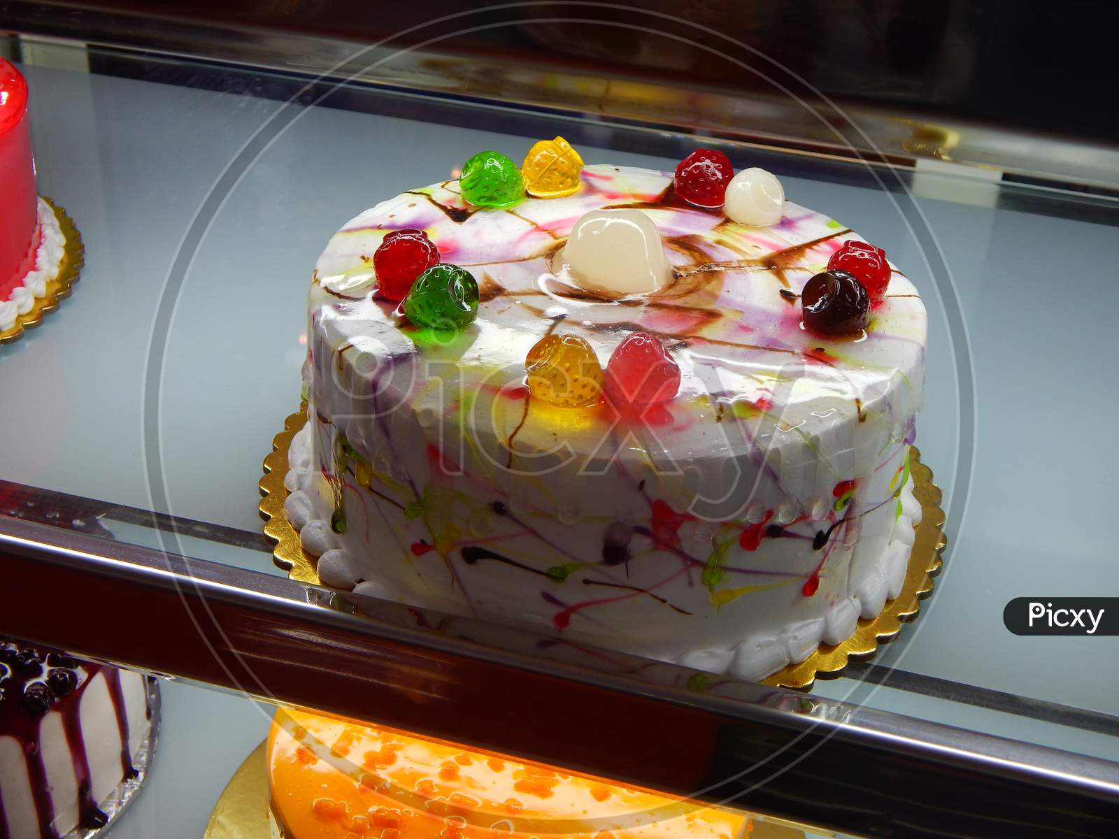 Image of In The Front View Of Cake , In Background Lots Of Light And  Decoration-LI877582-Picxy