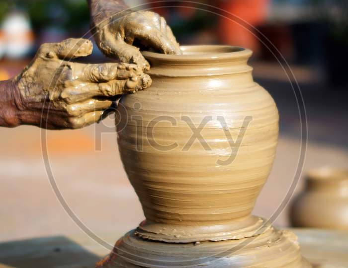 Stock Photo Of Potter Making A Eathen Vase On The Wheel In Outdoors