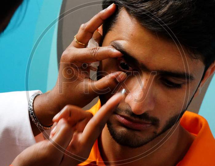 Indian Doctor Checking Patient Eye To Insert Contact Lens In A Clinic