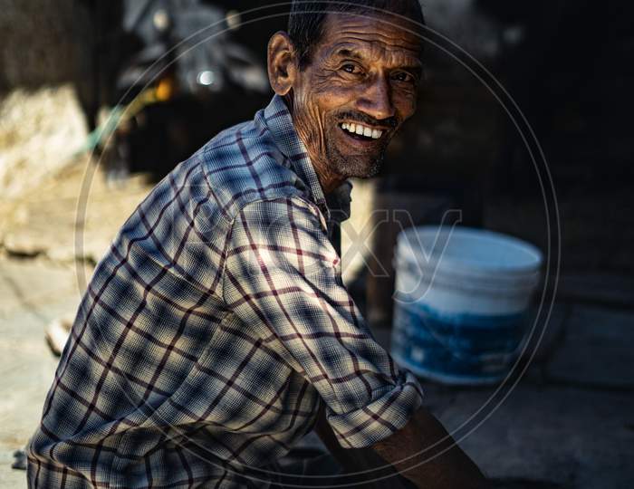 Almora, Uttarakhand- October 15 2021- A Portrait Of An Indian Village Poor Man Working In His Home In The Morning.