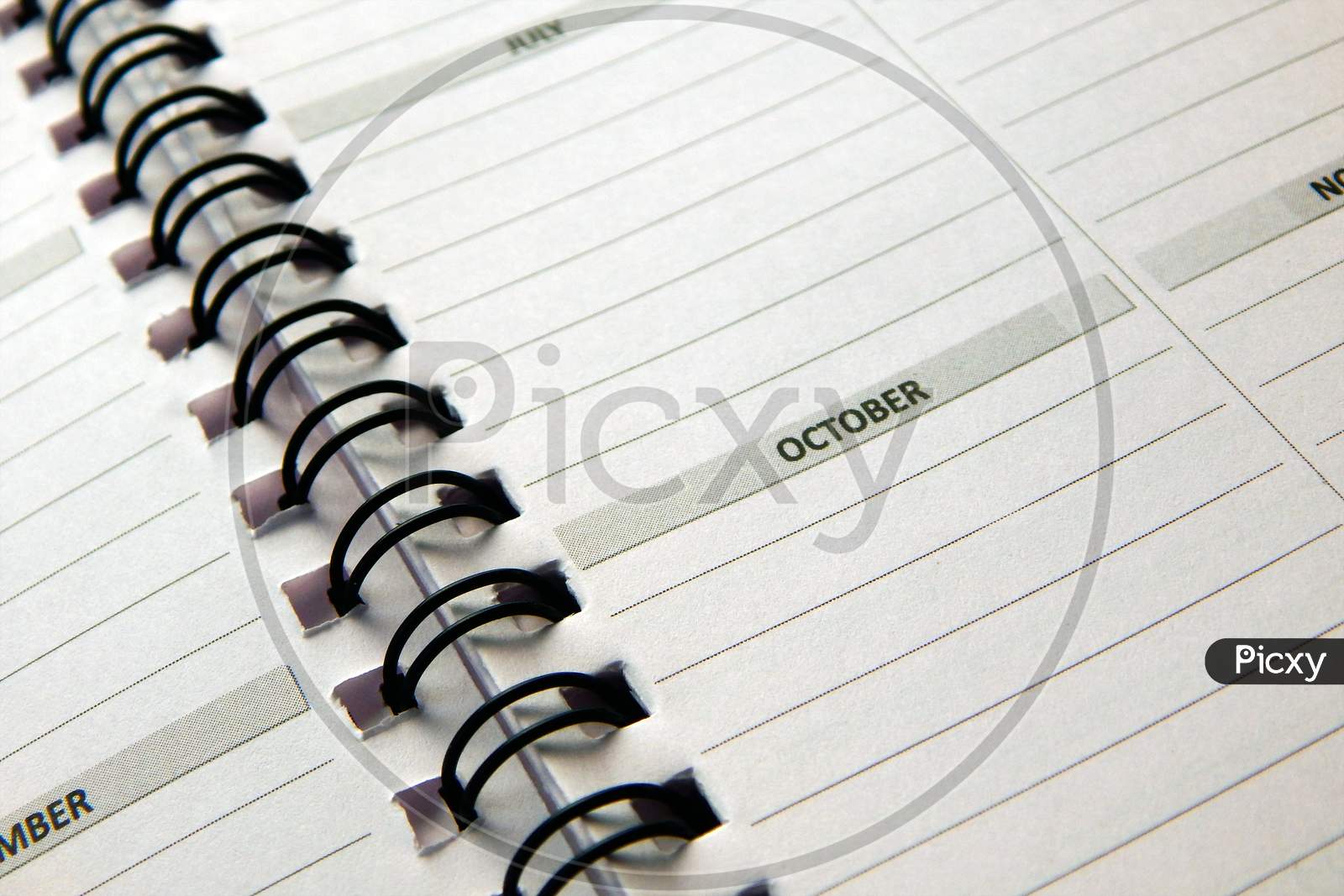 View Of Pages In Spiral Bound Monthly Activity Planner Book Or Diary