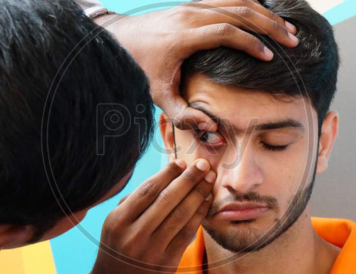 View Of Indian Doctor Checking Patient Eye To Insert Contact Lens In A Clinic