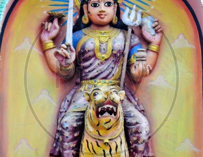 Indian Hindu Goddess Durga Sitting On Tiger With Weapons Wall Art On The Temple Wall