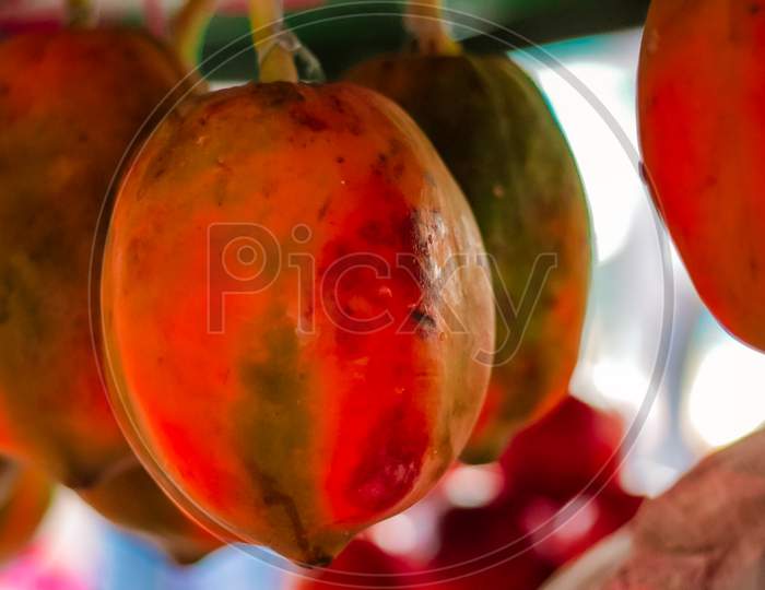 The papaya fruits on a wooden table and a rustic fabric at the background