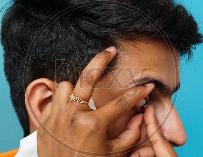 Close-Up View Of Indian Doctor Checking Patient Eye To Insert Contact Lens In A Clinic