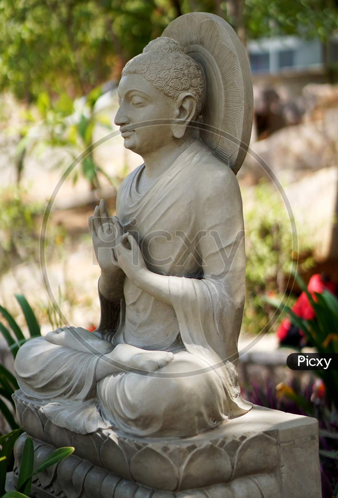 View Of Stone Carving Of God Buddha In Meditating Pose Under The Tree,In An Indian Monastry