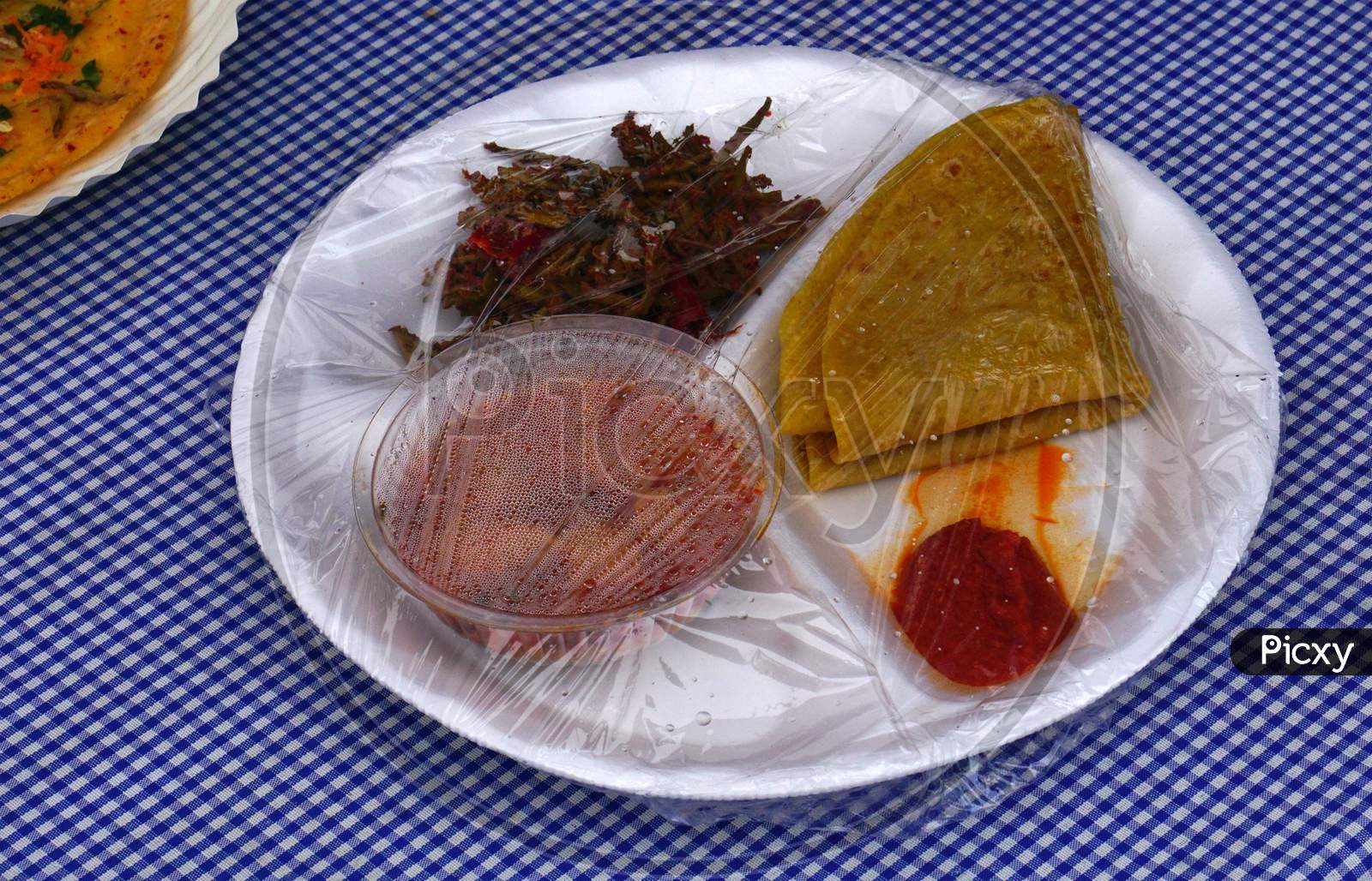 View Of Packaged Indian Street Food Chapathi,Curry, Pickle And Fried Vegetable Curry