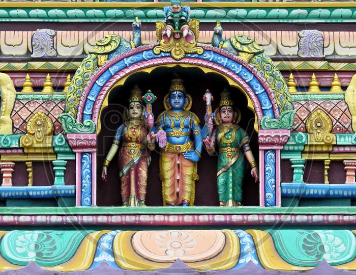 Indian Hindu God Balaji Or Venkateswara And Spouses Statues On Temple Tower Or Gopuram