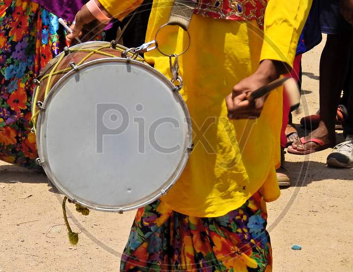 Indian Hindu Man Playing Drum  During Religious Celebration