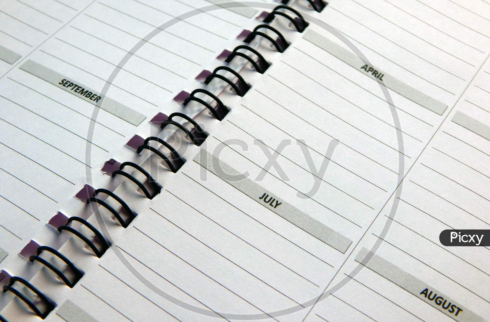 View Of Pages In Spiral Bound Monthly Activity Planner Book Or Diary