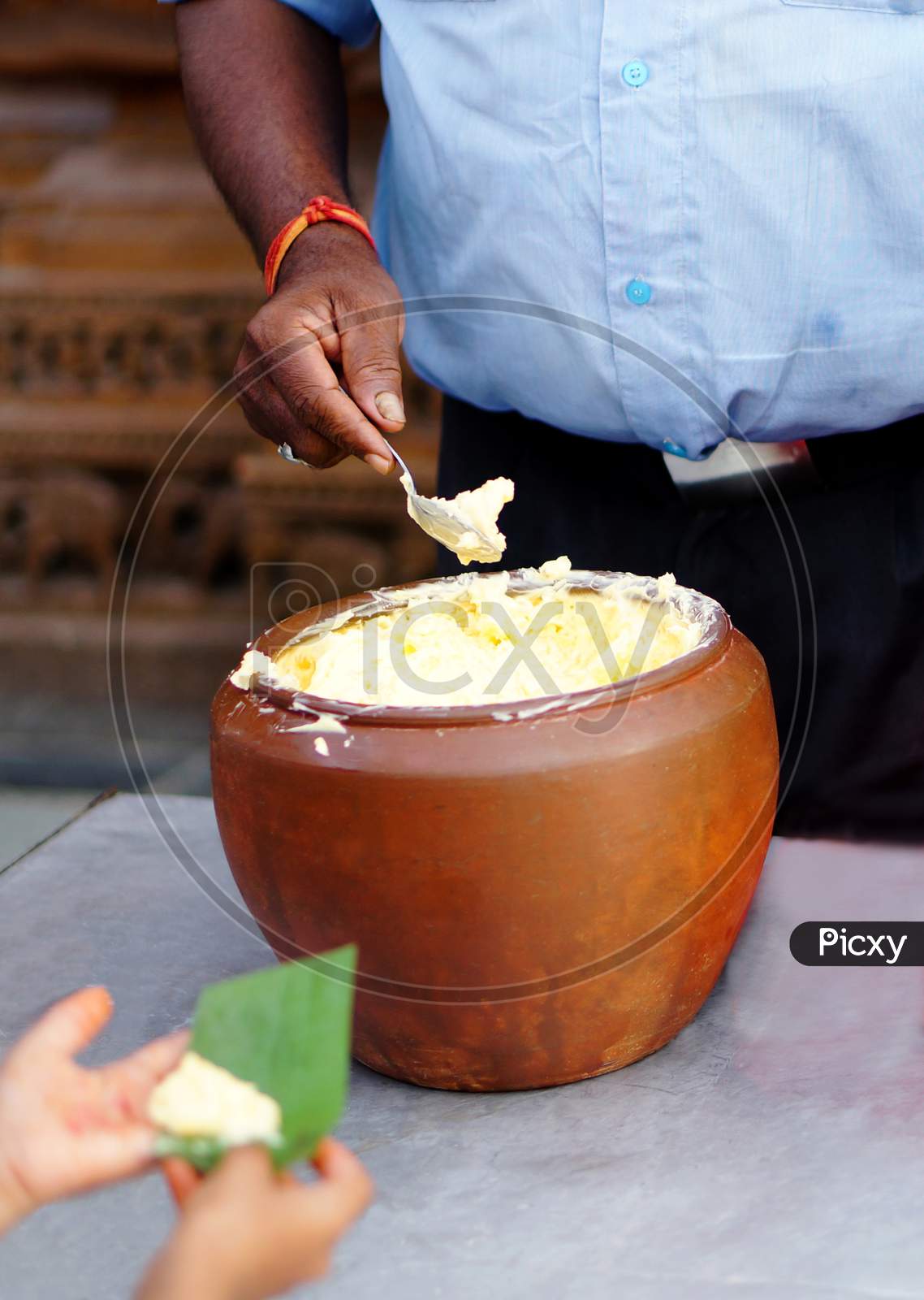 Indian Hindu Distributing Prasad Butter To Devotees To Eat As Blessed Food By God During Krishnastami Festival