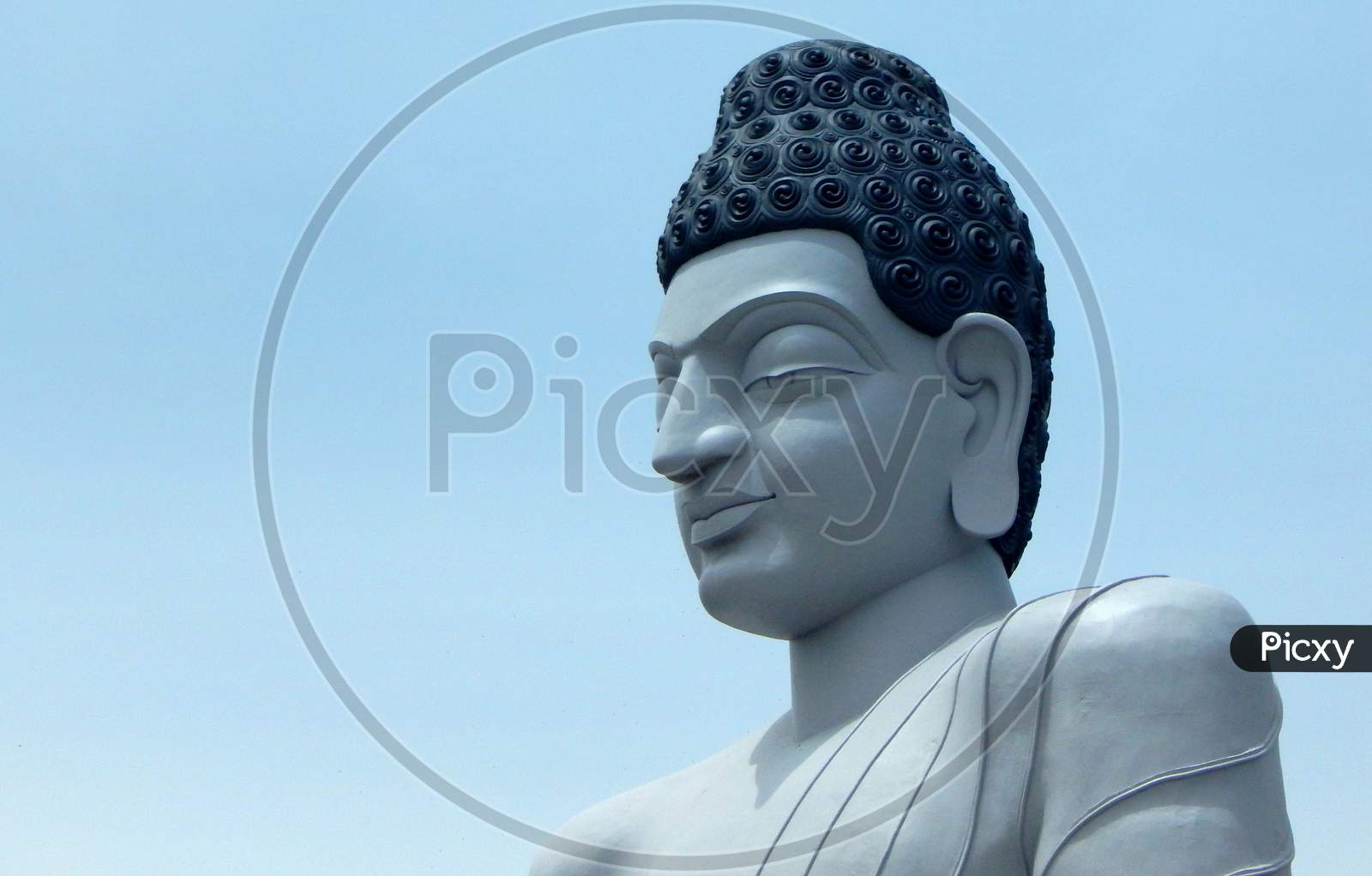View Of Head Or Portrait Of Buddha Against Blue Sky