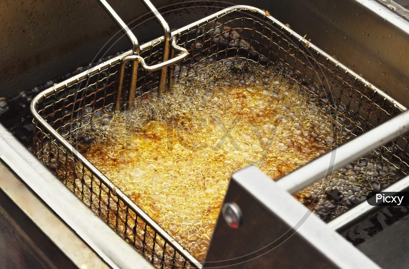 View Of Deep Frying Of Spring Or Tornado Potato Chips,In Oil