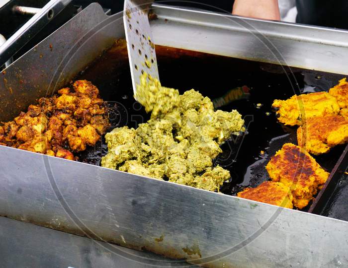 Indian Street Food Vendor Frying Different Tyes Of Meat Items On A Pan