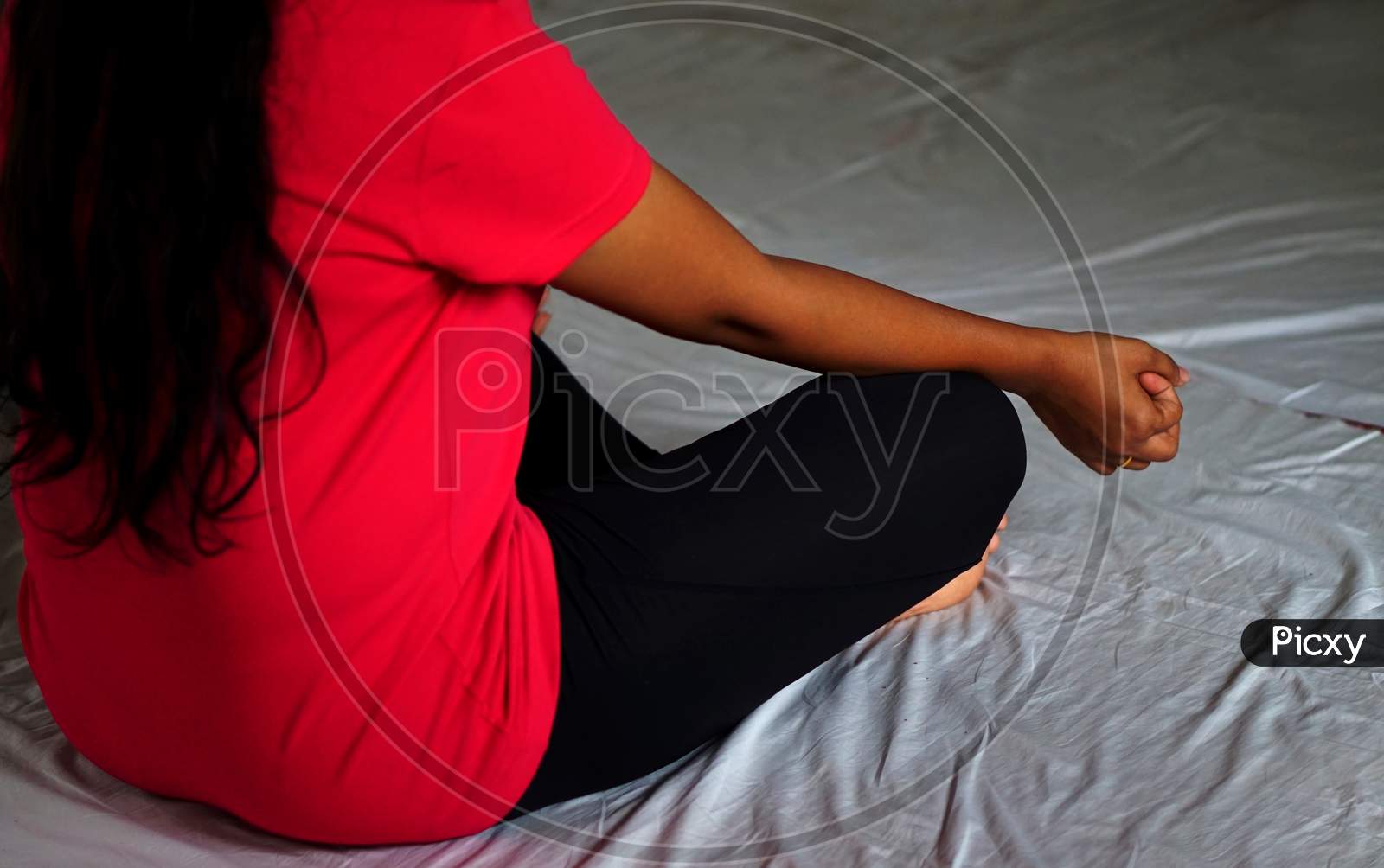 Indian Woman Practicing Yoga In Sitting And Meditating Pose