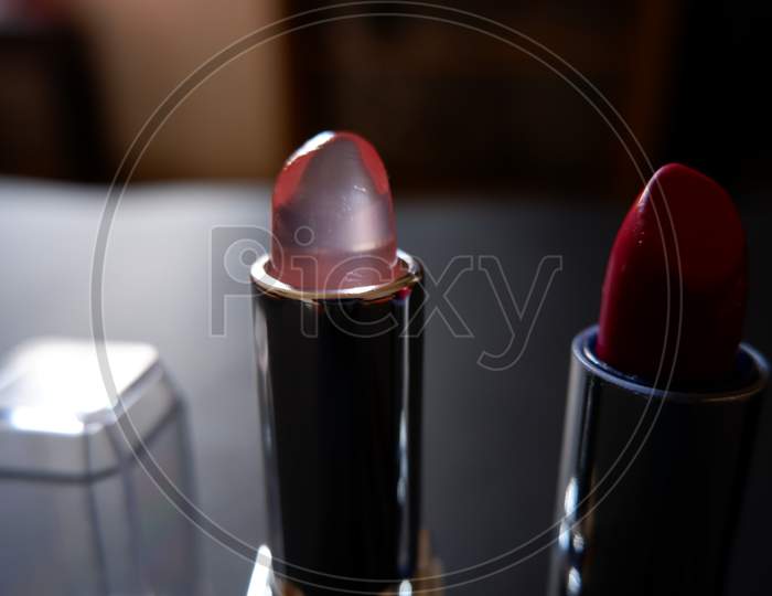 closeup view of Lip gloss and lipstick with cover