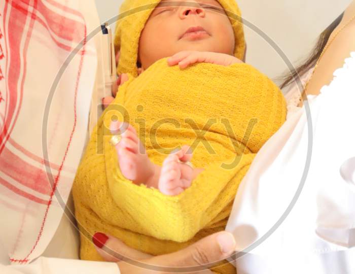 Cute Arabic Girl In Yellow Blanket And Head Scarf Lying In Parents Hands Newborn Baby Wallpaper