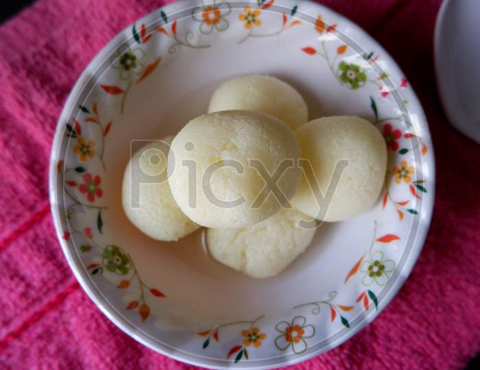 Top view of Rasgulla served in white printed bowl