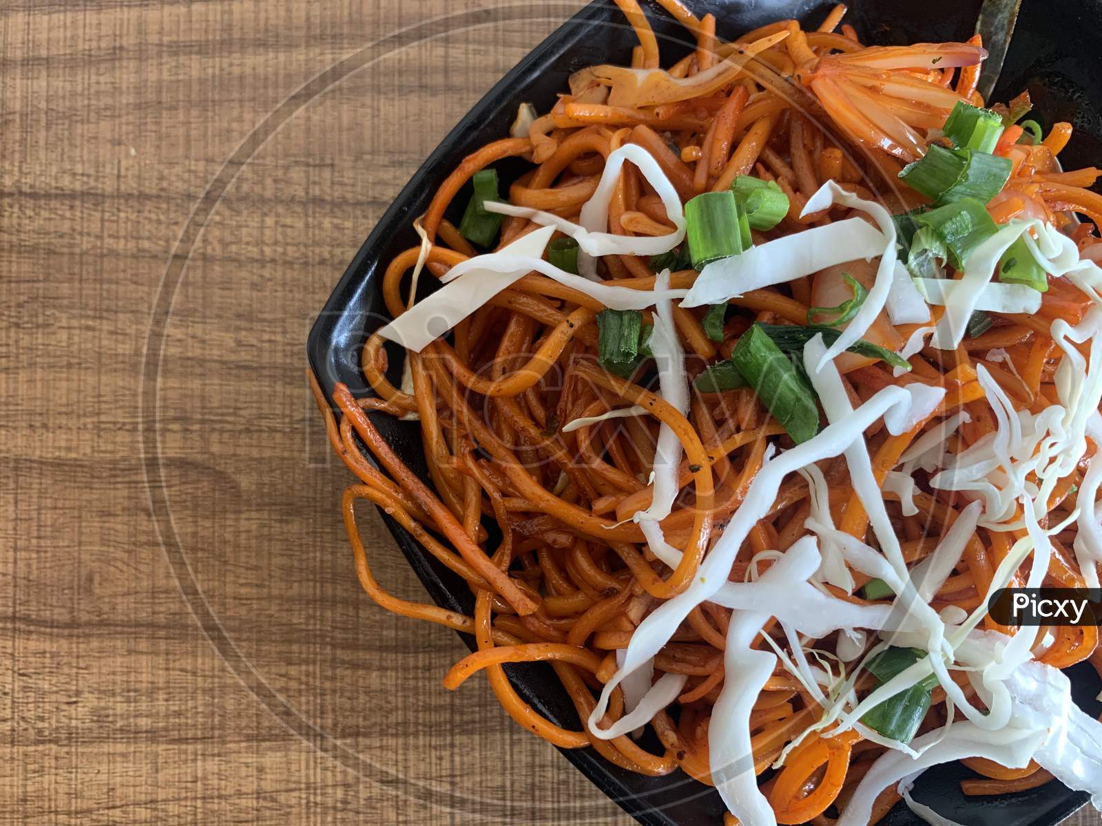 Vegetarian Schezwan Noodles or Vegetable Hakka Noodles or Chow Mein in bowl. Schezwan Noodles is indo-chinese cuisine hot dish with noodles, vegetables and chilli sauce
