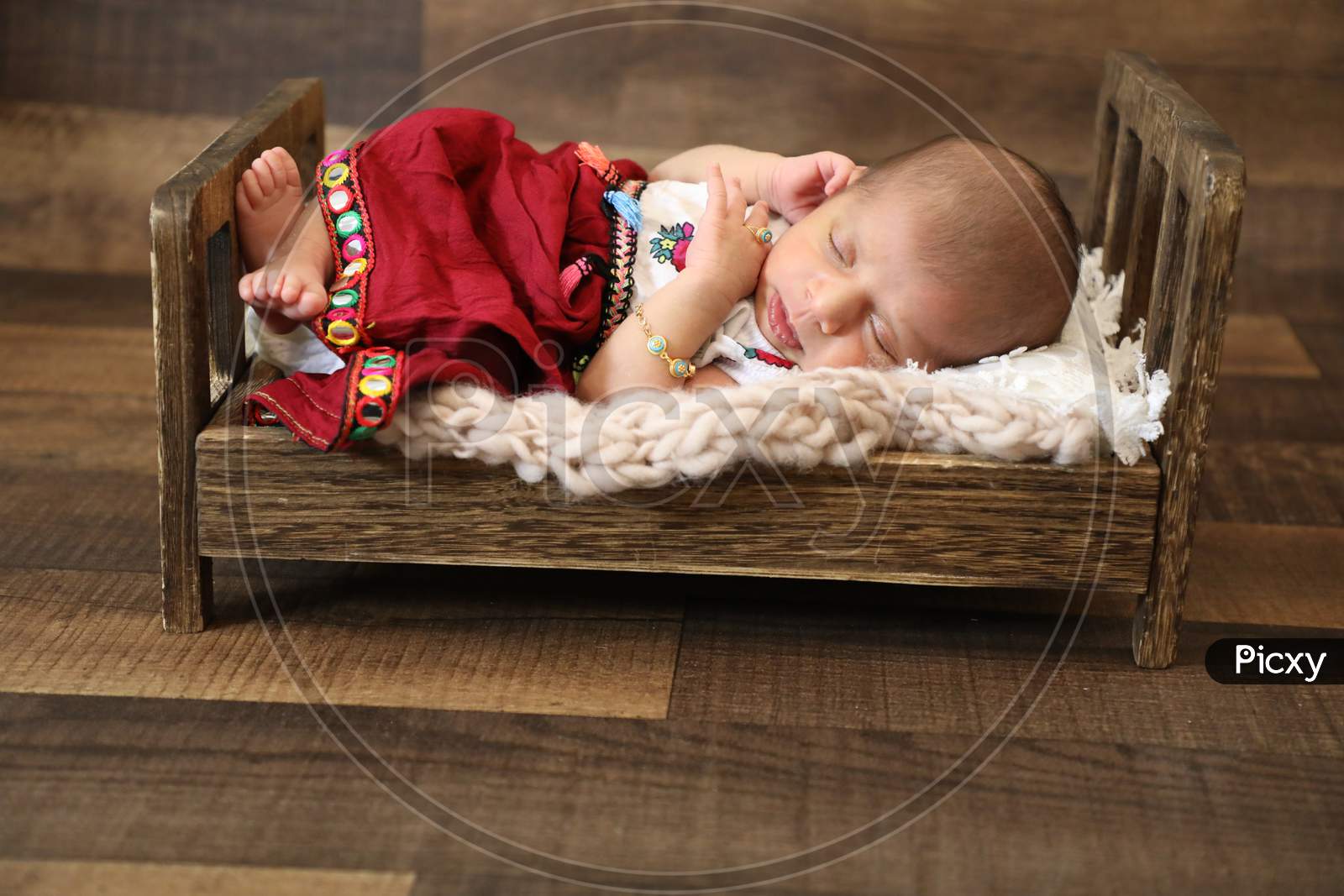 Beautiful Little Girl Sleeping And Posing On Wooden Baby Bed Colorful Floral Dressing